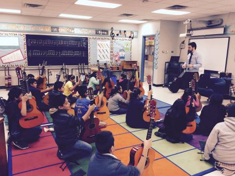 Toby Rodriguez with the guitar class at Widén Elementary School