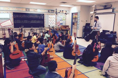 Toby Rodriguez with the guitar class at Widén Elementary School